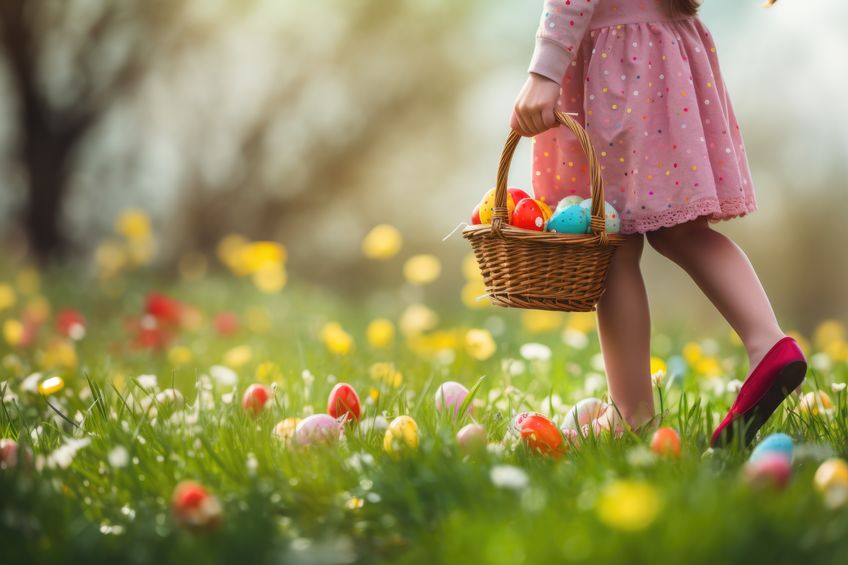 Child on and Easter egg hunt in a field